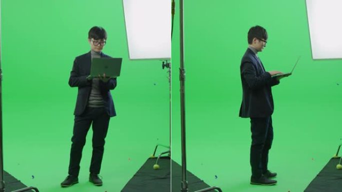 2合1绿屏拼贴: 英俊的亚洲商人穿着西装，站着，拿着笔记本电脑，使用它，打字。多角度最佳价值包: 正