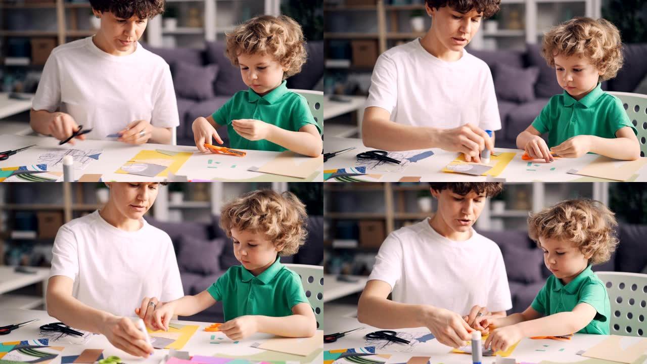 小男孩帮助他的母亲设计师在家创作彩色纸拼贴画