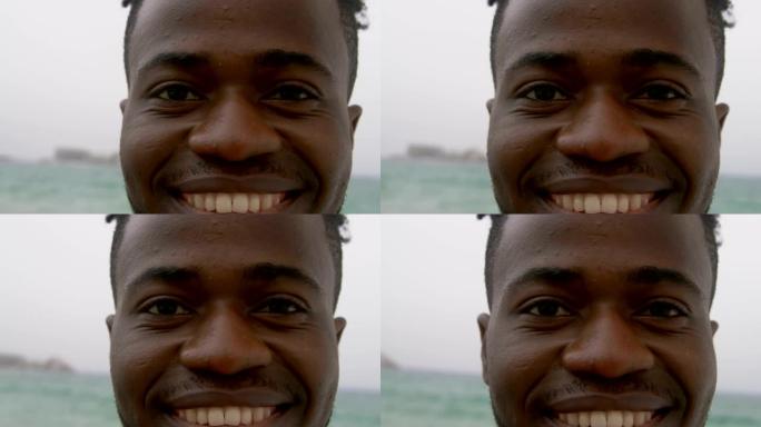 非裔美国男子站在海滩上的特写4k