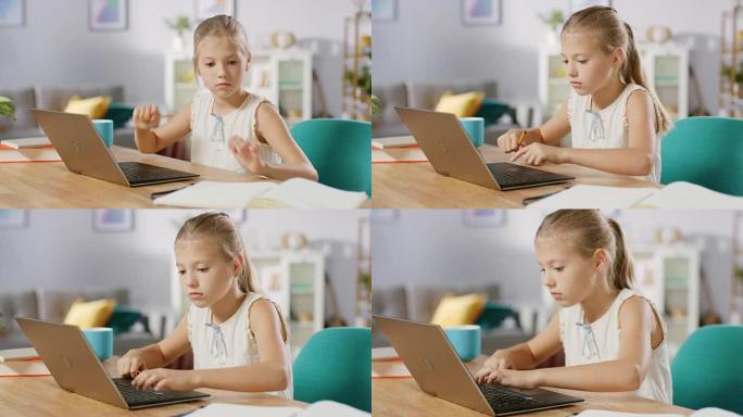 聪明的小女孩在客厅里做作业。她坐在办公桌前，用笔记本电脑，用笔在课本上写字。