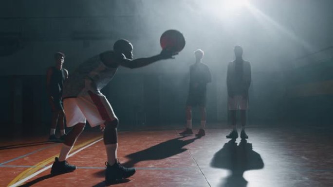 年轻职业男球员的电影慢动作特写镜头正在健身房练习篮球锻炼