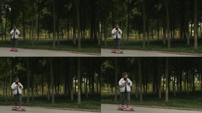 用手机玩滑板的亚洲少女