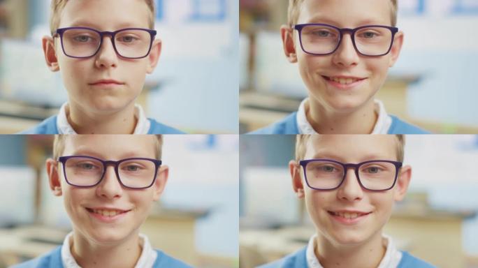 一个戴着眼镜的可爱的小男孩的肖像学校的书桌，开心地微笑着。聪明的小女孩，带着迷人的微笑坐在教室里。特