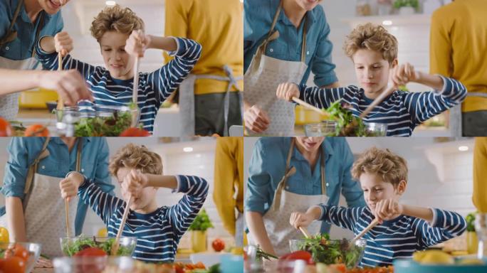 在厨房: 母亲和可爱的小男孩一起烹饪健康的晚餐。妈妈教小儿子健康的习惯，以及如何在沙拉碗中混合蔬菜。