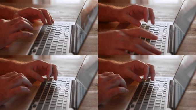 男人的手在家里的笔记本电脑上编码。使用便携式计算机的人。Man程序员编写代码