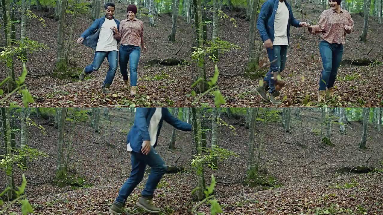 多种族夫妇在森林中踢干树叶的慢动作视频