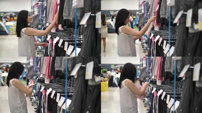 亚洲妇女在服装店购物服装