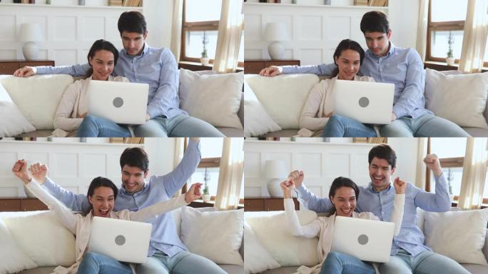 喜出望外的年轻夫妇在笔记本电脑上在线获胜，庆祝胜利