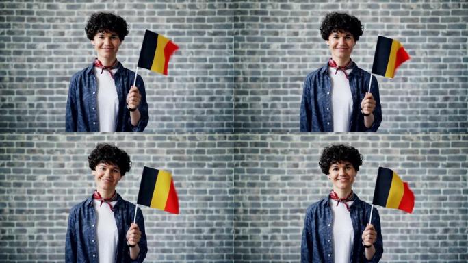 手持德国官方国旗微笑的美女慢动作肖像
