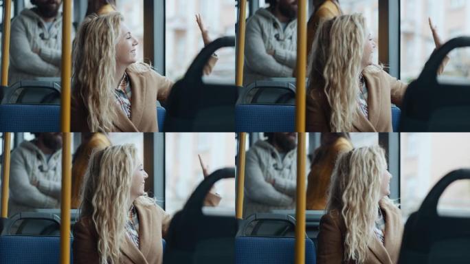 女人从公交车上穿过窗户挥手