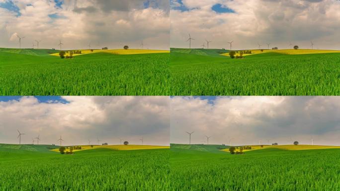 风力涡轮机在远处旋转的绿地上的T/L云景