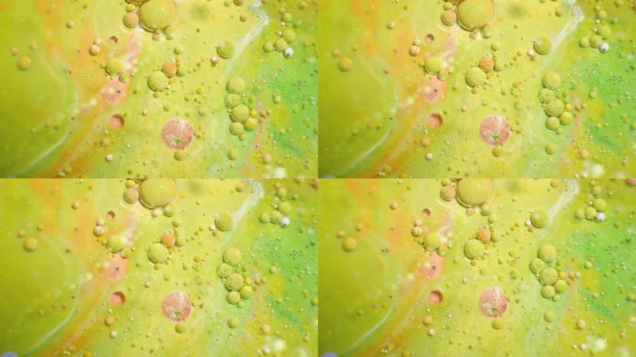 4k镜头。水中彩色液体墨水。颜色抽象。水中的气泡涂料。油漆在水中的慢动作。多色背景液体涂料