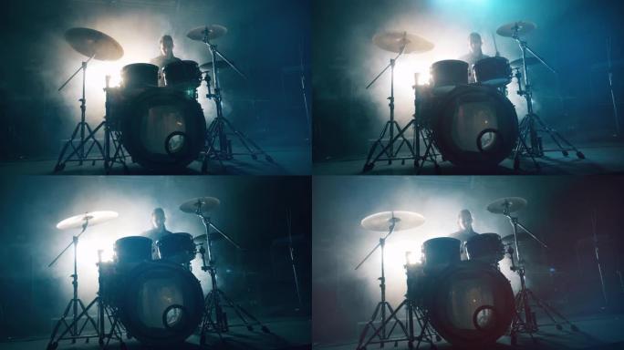 黑暗工作室，一个男人在排练打鼓。架子鼓，黑暗中的架子鼓，鼓手演奏音乐会。