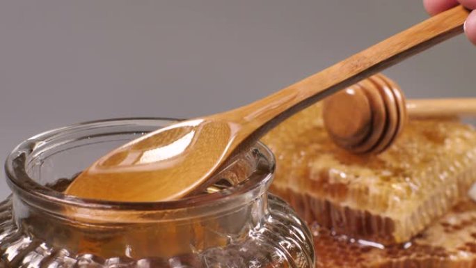 蜂蜜勺子流入罐子，特写