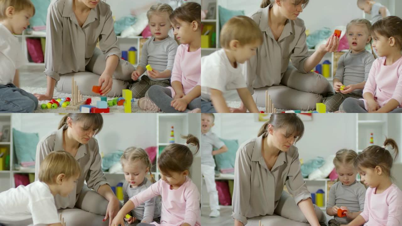 女教师和孩子在幼儿园玩益智玩具
