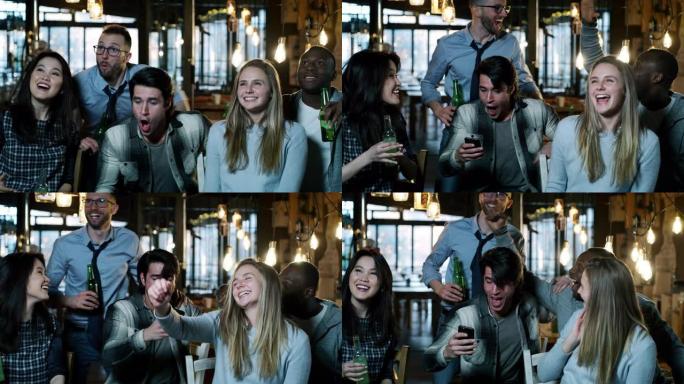 快乐的三个大学朋友在酒吧里一起喝啤酒和欢呼的慢动作