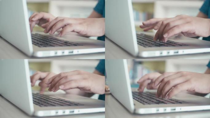 女人在笔记本电脑键盘上打字，多莉射击