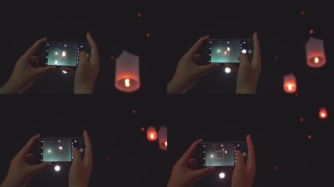 女人用智能手机手拍天灯图片