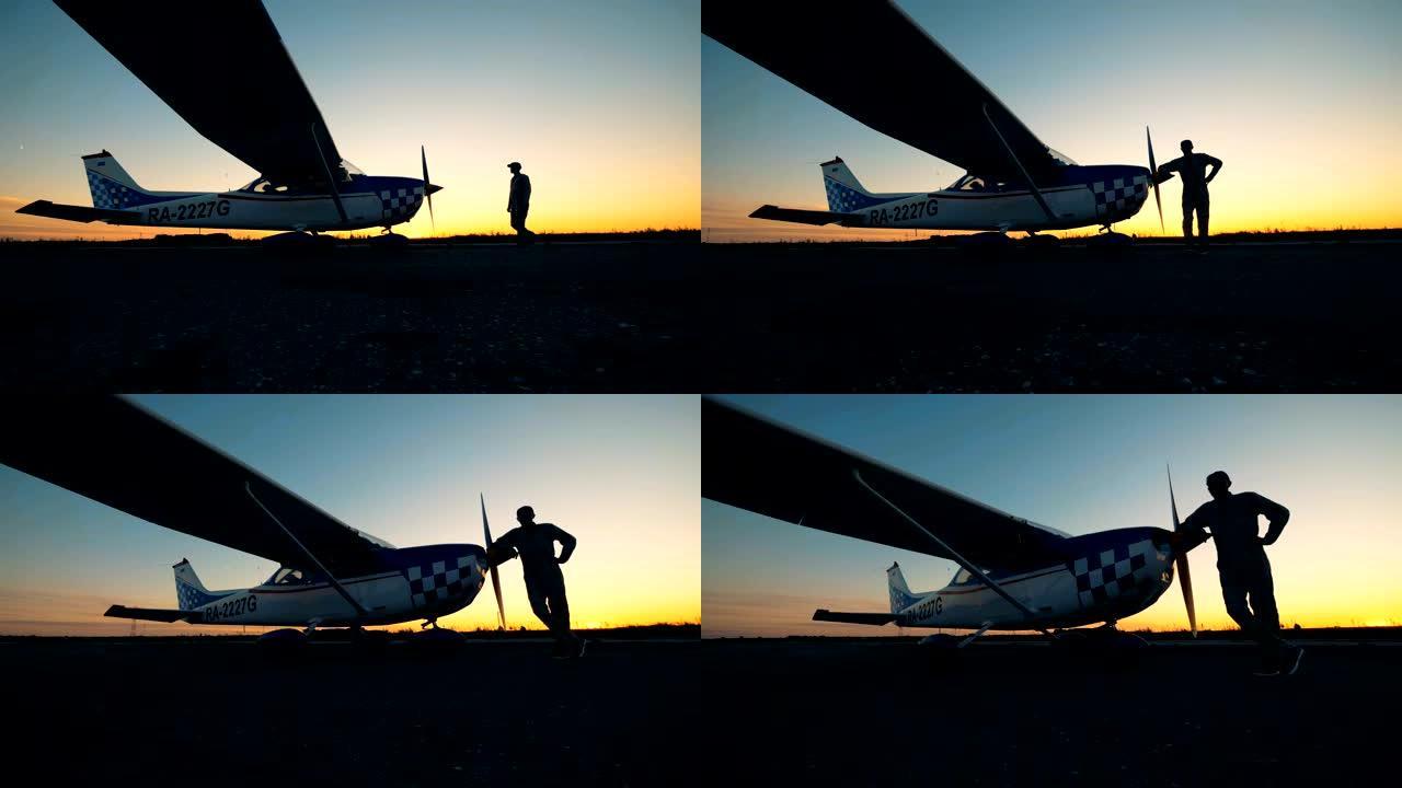 站在日落背景下飞机附近的人。小航空概念。