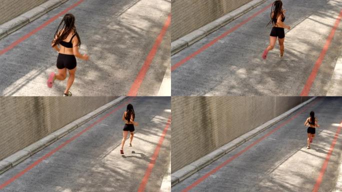 在城市4k慢跑的非洲裔美国妇女的高角度视图