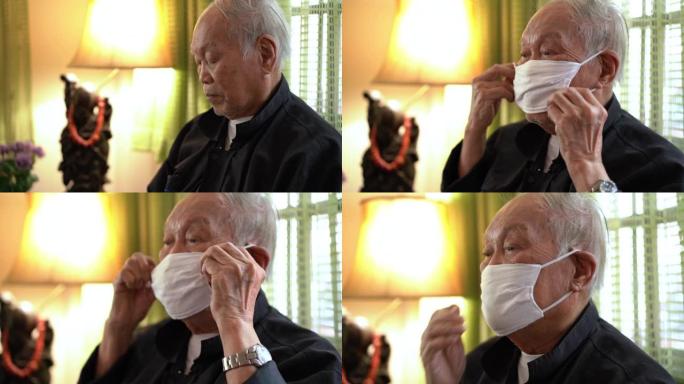 资深亚裔男子在家中戴空气污染口罩