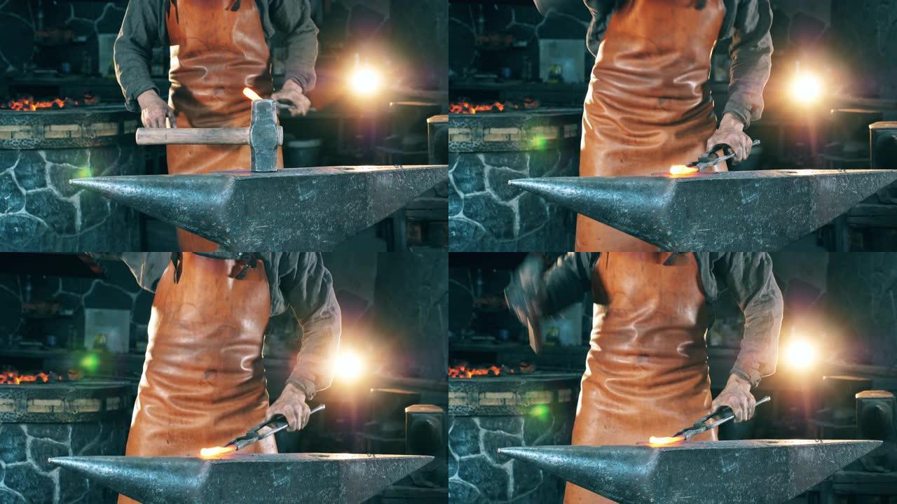 男子在锻造炉工作时用锤子击打热刀。