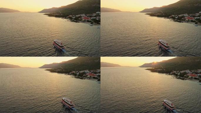 WS鸟瞰船在日落时沿着宁静的海洋行驶，佩列萨克，克罗地亚