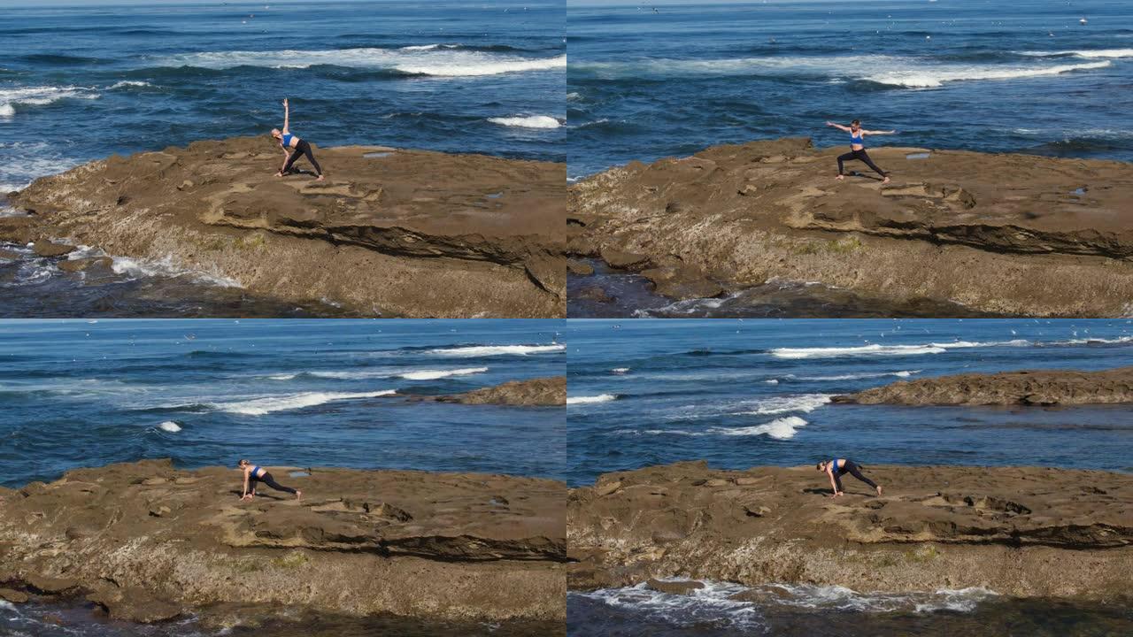 阳光明媚的早晨，女人在外面的海滩上做瑜伽姿势的空中镜头