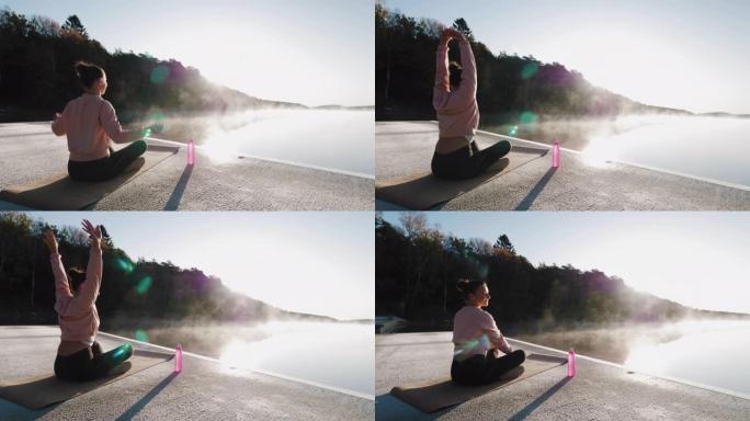 在湖边做瑜伽的女人