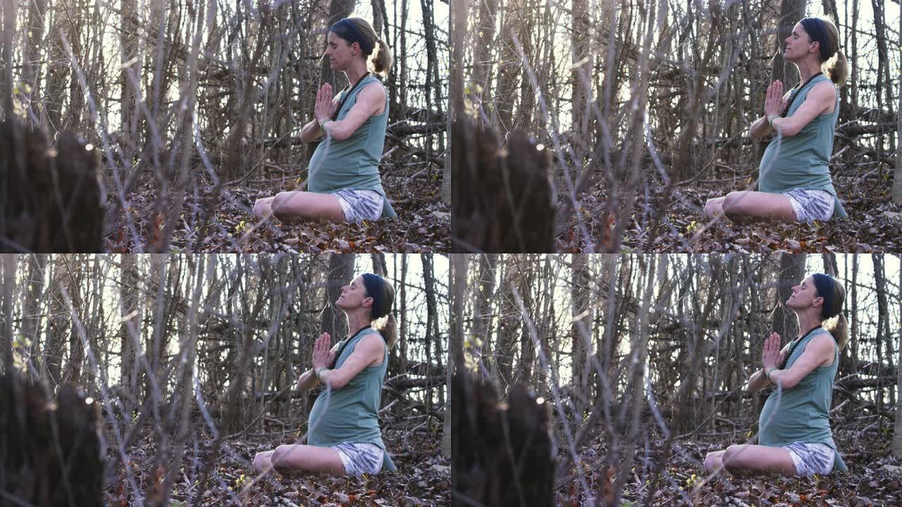 年轻孕妇在森林里练习瑜伽和正念