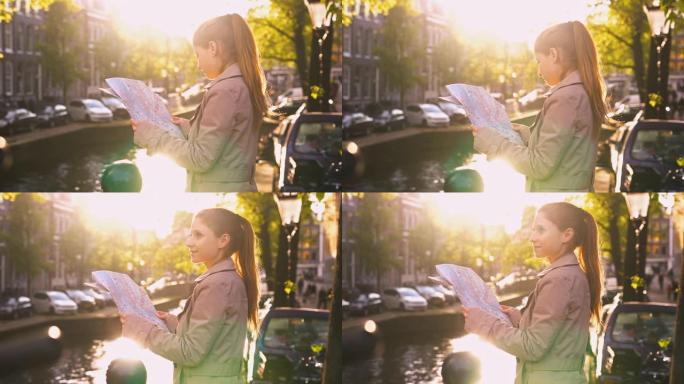 在阿姆斯特丹度假的女性游客，沿着运河散步，观光，在美丽的晴天看城市地图