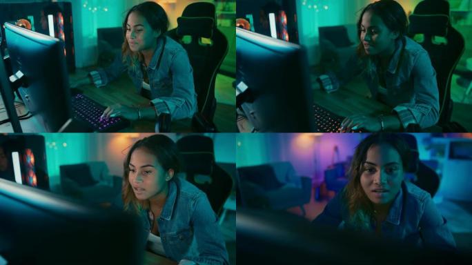 美丽而兴奋的黑人玩家女孩正在她的个人电脑上玩在线视频游戏。房间和电脑有彩色温暖的霓虹灯。在家舒适的夜