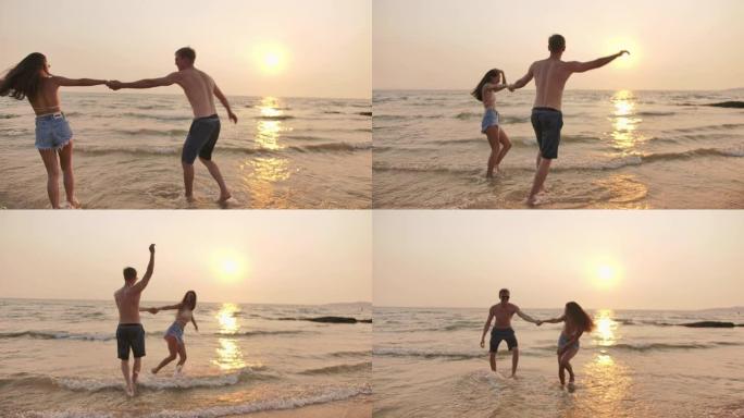 4k分辨率混合种族年轻夫妇在海滩上跳舞和享受生活，手持慢动作场景，手持B-roll