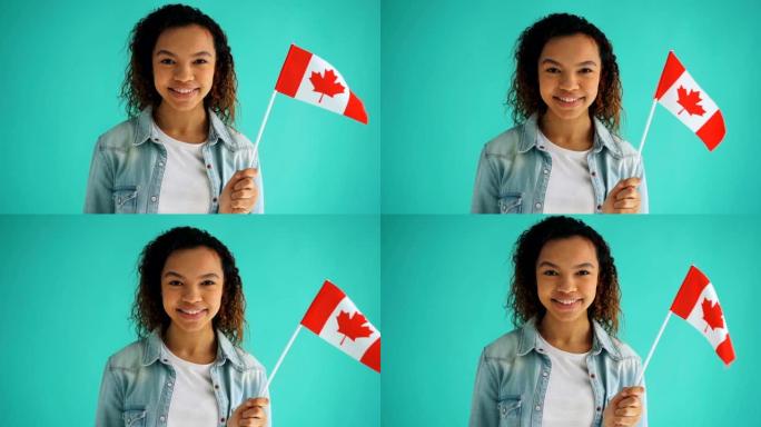 加拿大公民混血少女手持国旗微笑慢动作