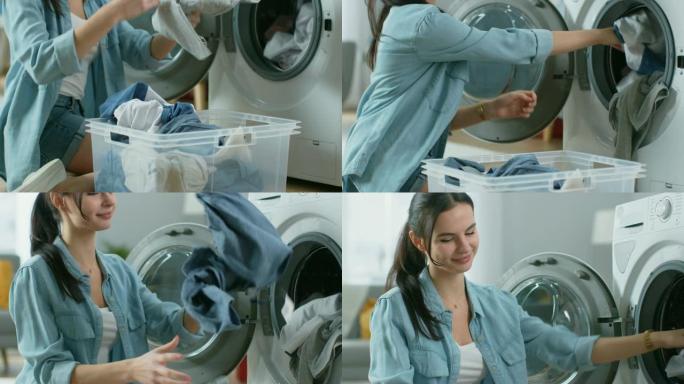 一个穿着家常衣服的美丽年轻女子坐在洗衣机前的特写镜头。她给洗衣机装上脏衣服。明亮宽敞的客厅，室内现代