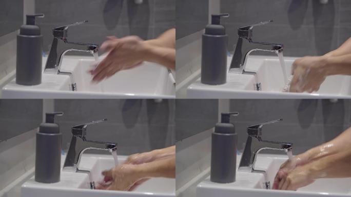 男人用肥皂和水洗手