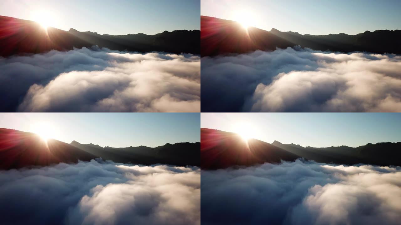 空中拍摄在日出和蓝天的云层上方
