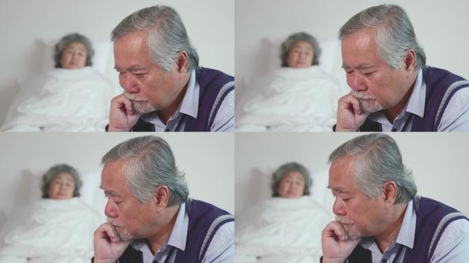 老人与老人戴着胡须坐着。由于他的妻子的病，他坐在前面，而他的妻子躺在背后，代表着老人的爱心，互相照顾