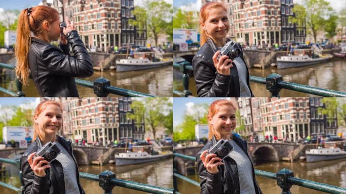 女游客在阿姆斯特丹旅行，用老式模拟相机拍摄运河照片，微笑着进入相机
