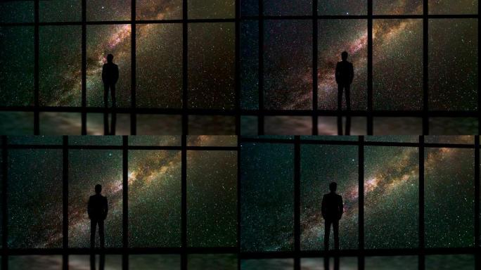 站在星星背景上靠近窗户的男性。时间流逝