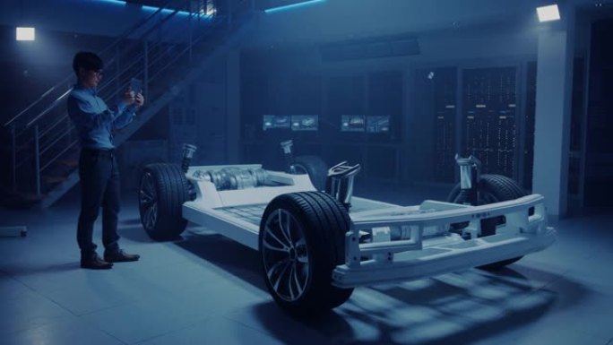 在电动汽车底盘平台上工作的汽车工程师，使用平板电脑增强现实与3D cad软件建模。创新设施: 带车轮