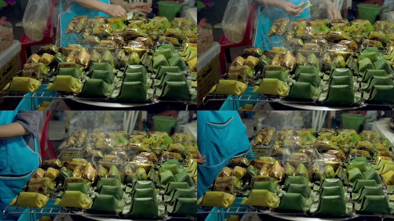 亚洲高级妇女在农贸市场购买泰国甜点