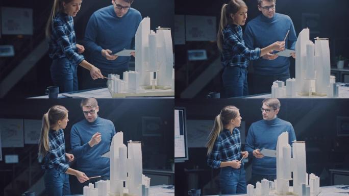 在创意建筑局，两名专业工程师在市区模型上工作。城市规划者致力于功能性建筑模型。他们交谈并使用数字平板