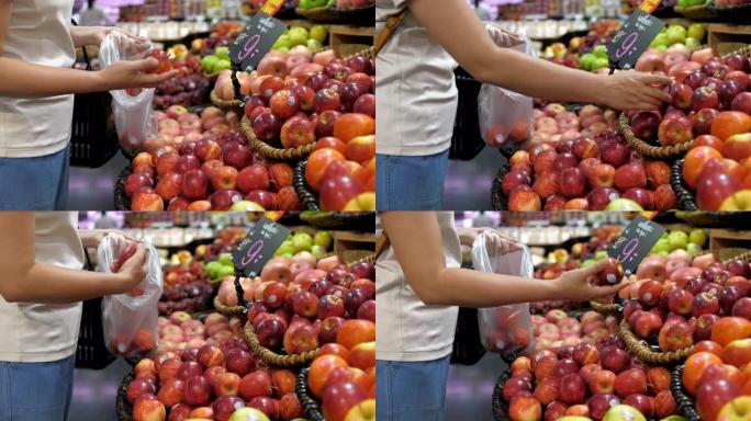 女人选择水果并在超市购物，慢动作