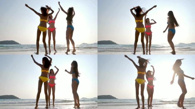 一群朋友女孩在海滩上玩得开心。女孩在海滩上跳舞。暑假、旅行、人和度假概念。假期-iStock