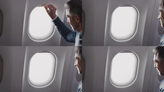 商人打开私人飞机的窗户