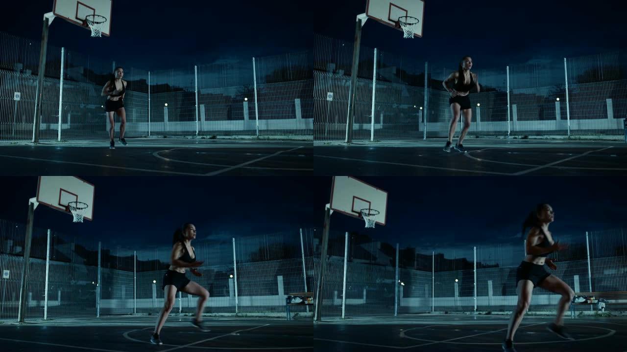 美丽精力充沛的健身女孩做步法跑步训练。她正在一个有围栏的室外篮球场里锻炼身体。居民区雨后的夜间录像。
