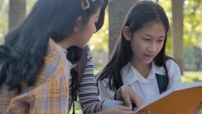 亚洲青少年女学生三人校园帮助朋友赶上并在学校学习书本辅导。返校教育知识概念