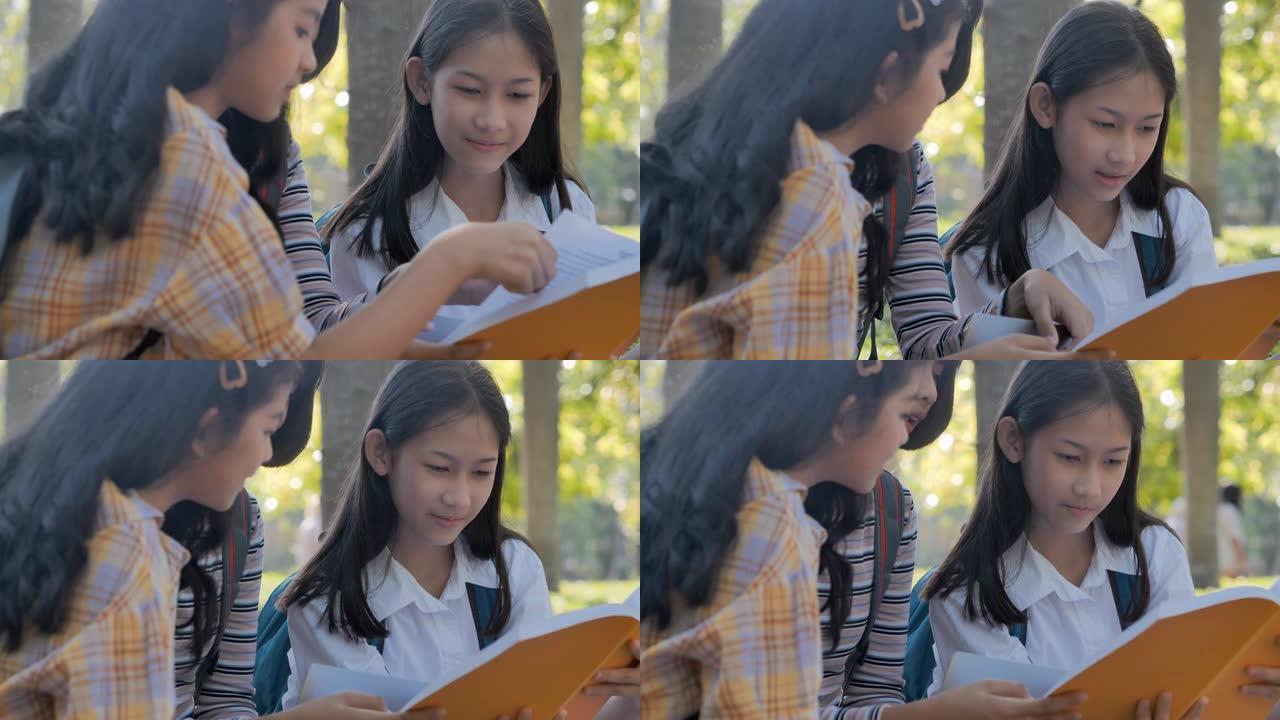 亚洲青少年女学生三人校园帮助朋友赶上并在学校学习书本辅导。返校教育知识概念
