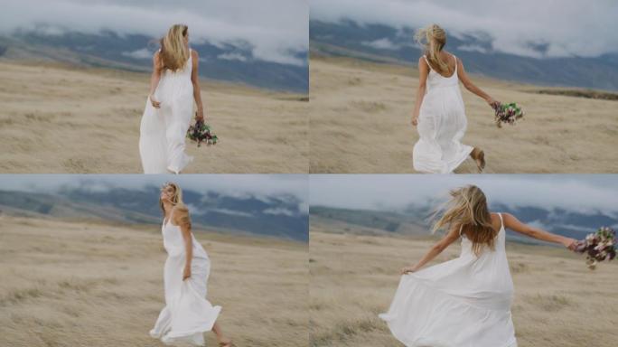 一个快乐的女人在开阔的田野里跳舞